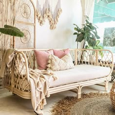 a living room with wicker furniture and plants