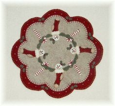 a red and white rug with snowmen in the middle on it's side