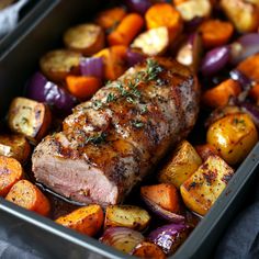 a pan filled with meat, potatoes and carrots