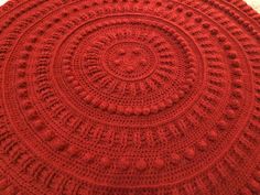 an image of a red doily that looks like it has been crocheted