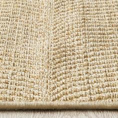 a close up view of a beige rug