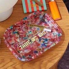 there is a tray that has confetti on it and other items around it