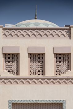 a large white building with three windows and a clock on it