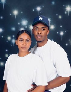 a man and woman posing for a photo in front of stars