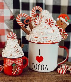 a cup filled with whipped cream and candy canes