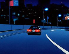 a car is driving down the road at night with city lights in the back ground