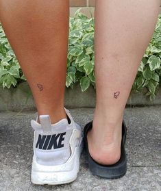 a woman's foot with a small tattoo on her left leg and the word nike written in black ink