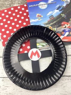 a paper plate that is shaped like a steering wheel with mario kart on it