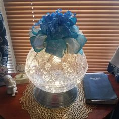 a glass vase sitting on top of a wooden table