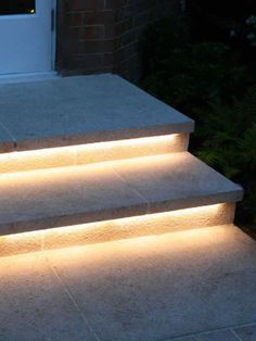 some steps lit up with lights in front of a door