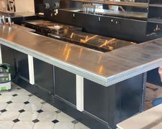 an empty restaurant kitchen with stainless steel counter tops