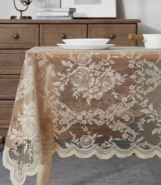 a table with a lace doily on it and a bowl sitting on top of the table