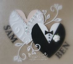 a wedding card with a tuxedo and bride's dress in the shape of a heart