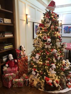 a christmas tree decorated with teddy bears and presents