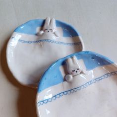 two ceramic plates with bunny bunnies on them