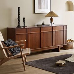 a living room with a chair, table and pictures on the wall