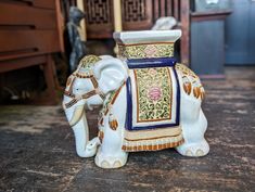 an elephant figurine sitting on top of a wooden floor