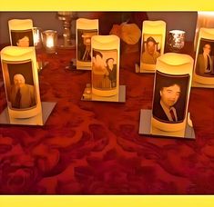 a table topped with candles and pictures of people