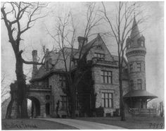 an old black and white photo of a large building with turrets on it's roof