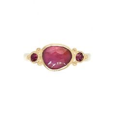 A warm pink sapphire is accented with a pair of burgundy Rhodolite garnets. Set in 14k gold with sterling silver seagrass band we are totally smitten with this ring. Approximate stone size: 9mm x 7mm Approx ct weight: 2cts Mohs Stone Hardness: 9 This one of a kind piece is handmade to order in Emily's Hudson Valley studio. If you have questions about sizing, shipping or need help deciding please reach out to us! Colored Stone Engagement Rings, Stacked Engagement Ring, Pink Wedding Rings, Birthstone Stacking Rings, Rhodolite Garnet Ring, Pink Sapphire Ring Engagement, Peach Sapphire, Pink Sapphire Ring, Sapphire Engagement Ring