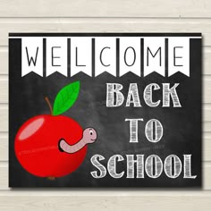 welcome back to school sign with an apple and worm on the front, blackboard background