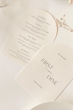 the menus are laid out next to each other on top of a white table cloth