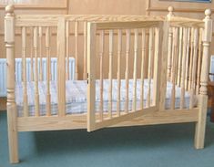 a baby crib in the corner of a room with blue carpet and wooden walls