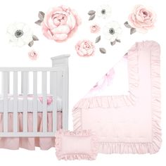 a baby crib with pink and white flowers on the wall next to it's bed