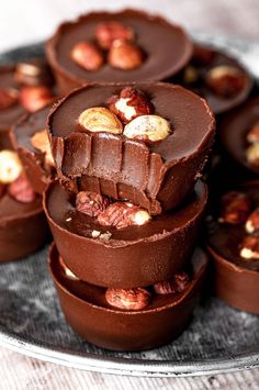 there are many pieces of chocolate with nuts in it on the plate next to each other