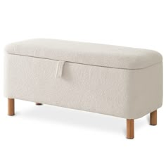 an upholstered bench with wooden legs