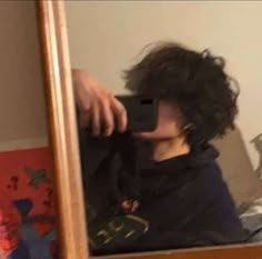 a man taking a selfie in front of a mirror