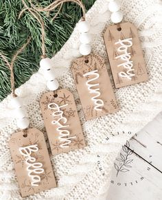 three tags with the word boo boo boo on them hanging from a christmas tree branch