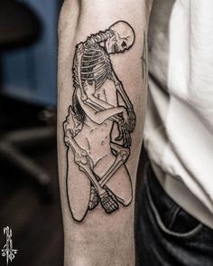 a man with a skeleton tattoo on his arm