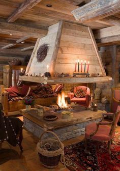 a living room filled with furniture and a fire place in the middle of it's fireplace