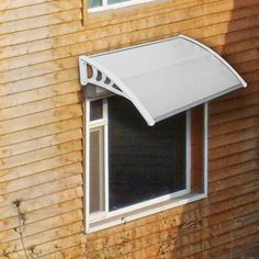 a white awning on the side of a brown building