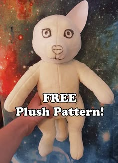 a hand holding a white stuffed animal with the words free plush pattern on it's face