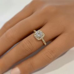 a woman's hand with a diamond ring on it