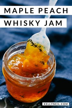 maple peach whiskey jam in a glass jar with a spoon sticking out of the top