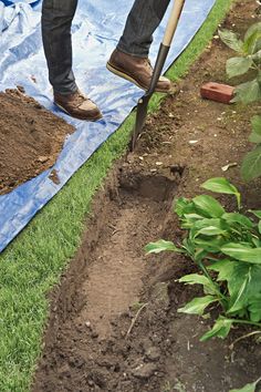 a man is digging in the ground with a shovel