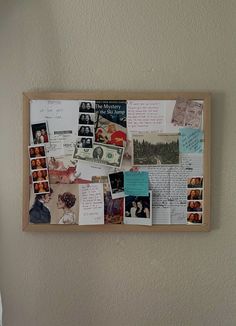 a bulletin board covered in photos and post it notes on the wall next to a bed