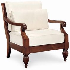 a wooden chair with white upholstered fabric on the armrests and arms