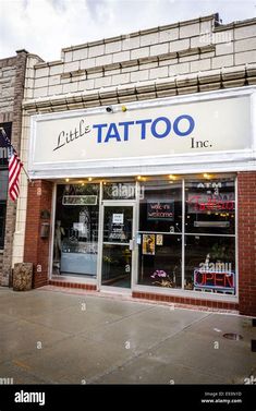 a little tattoo inc store front with an american flag in the window