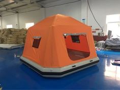 an inflatable tent sitting on top of a blue floor