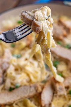 a fork full of pasta with meat and peas