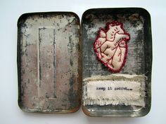 an old metal box with a heart patch in it