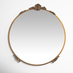 a round mirror hanging on the wall