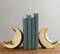 two bookends made out of concrete and brass