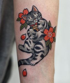 a cat is sitting on its hind legs with flowers and leaves around it's neck