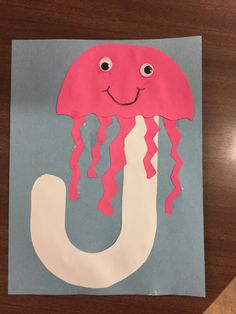 the letter u is made out of paper with a jellyfish on it