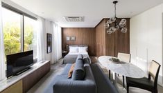 a living room filled with furniture and a flat screen tv sitting on top of a table